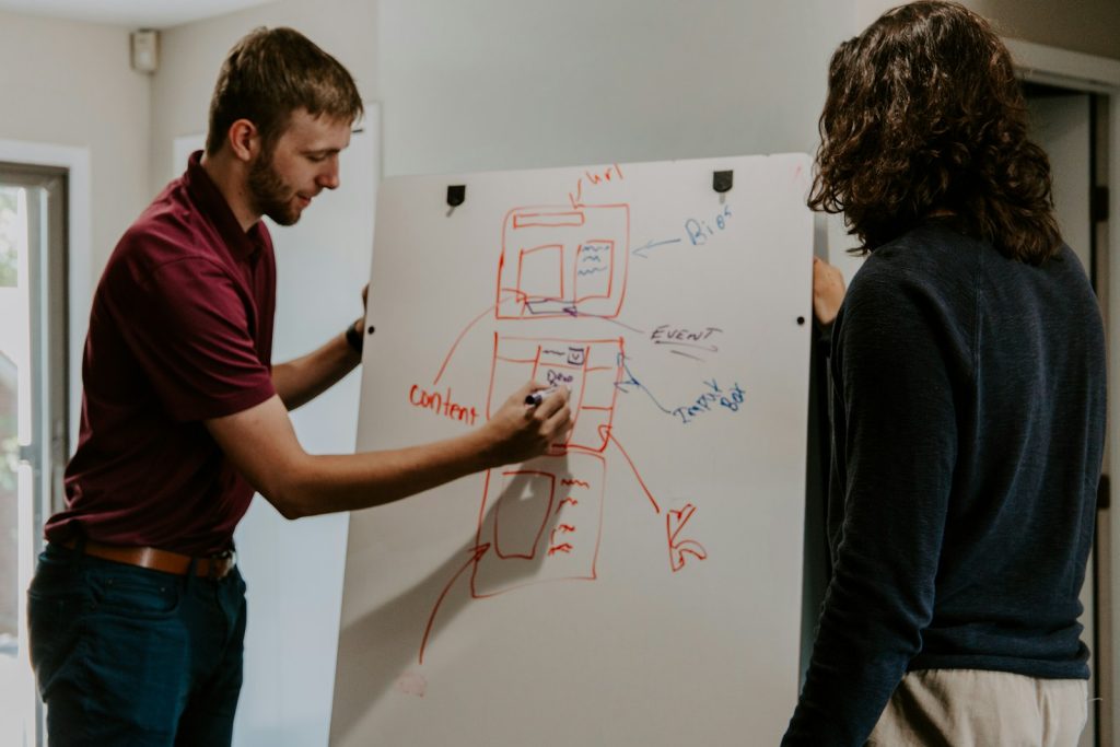 man drawing talent strategy on whiteboard